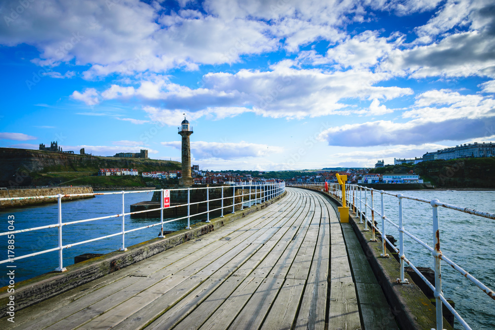 Whitby pier at the harbor entrance at Whitby in North Yorkshire, UK