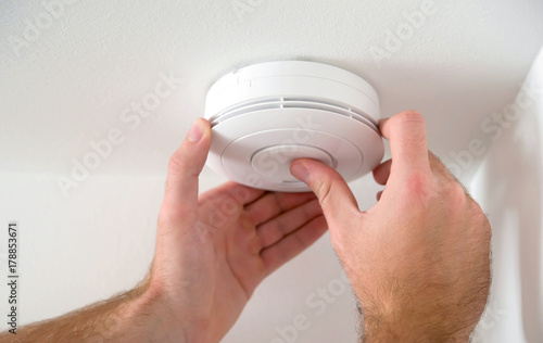 Man installing smoke detector