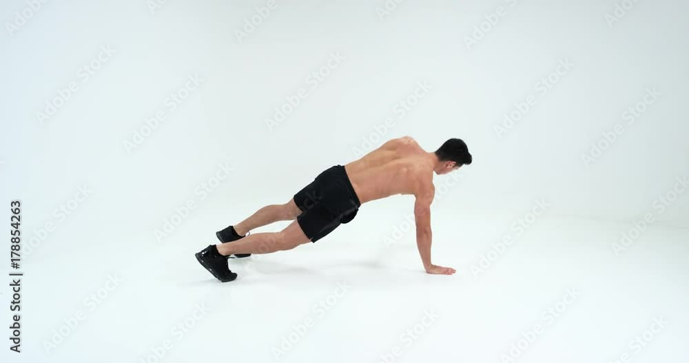 Weightlifter is exercising, shaking his hands from the floor. White background 4k. Weightlifter is exercising, shaking his hands from the floor. White background 4k.