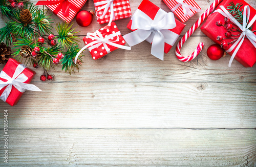Christmas background with red gift boxes on wooden board