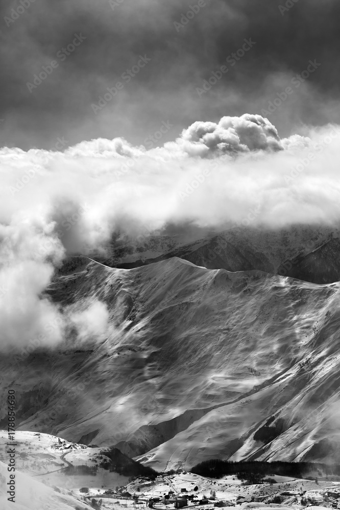 Black and white view on ski resort at mist with sunlight clouds Black and white view on ski resort at mist with sunlight clouds