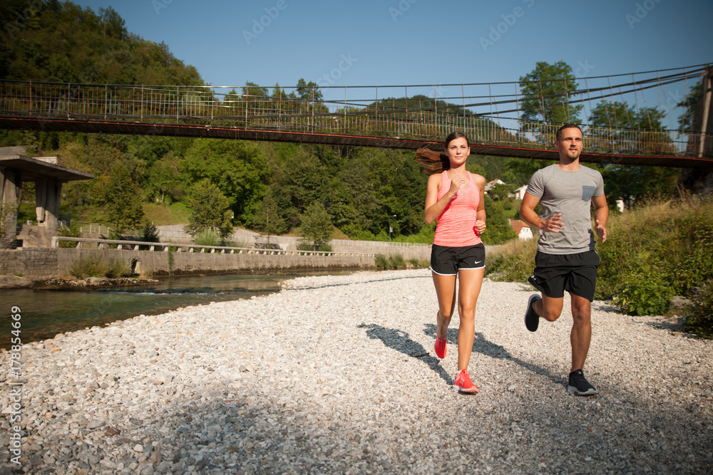 active young couple running in park