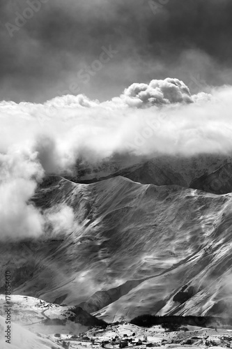 Black and white view on ski resort at mist with sunlight clouds © BSANI