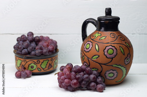 Grapes and antique wine jug
