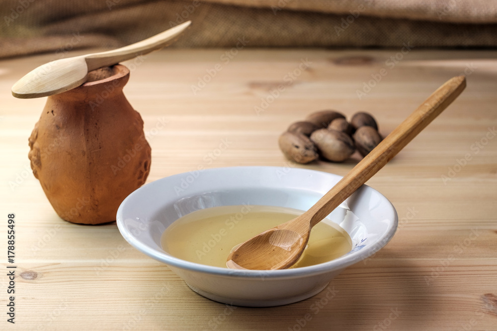 clay pot of honey next to the dish in which the honey clay pot of honey next to the dish in which the honey
