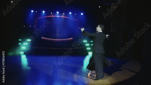 Beautiful young couple dancing tango on stage
