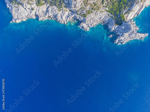 The view from the top. Trees and shrubs on a rocky island in the sea