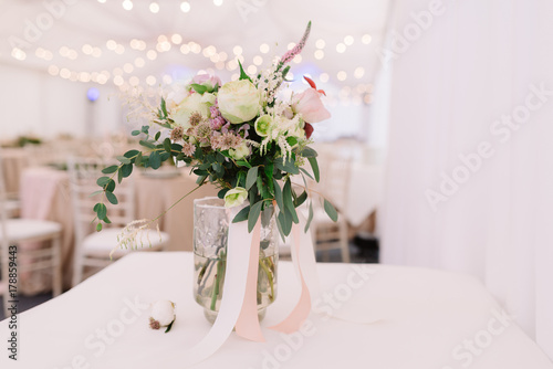 Floral bouquet for the wedding ceremony in transparent vase, landscape © Olga