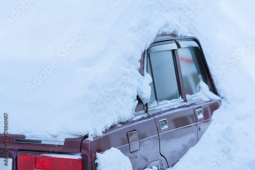 Old red car in the snowdrift