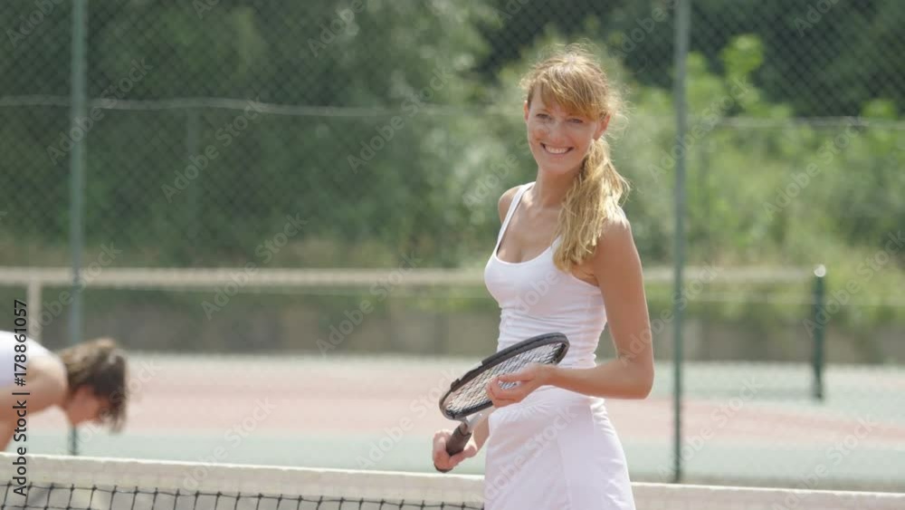 Portrait smiling tennis player on outdoor court in the summer Portrait smiling tennis player on outdoor court in the summer