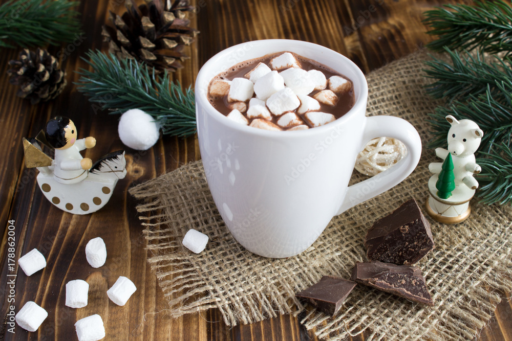 Hot chocolate with marshmallows in the white cup on the rustic background Hot chocolate with marshmallows in the white cup on the rustic background