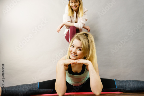 Woman in sportswear doing workout with trainer