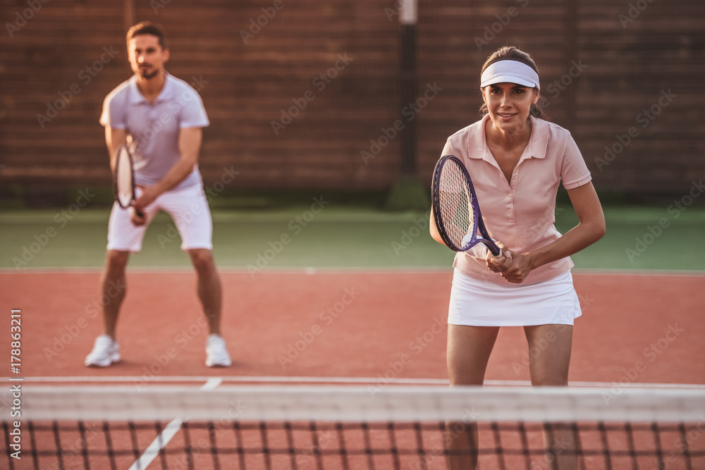 Couple playing tennis