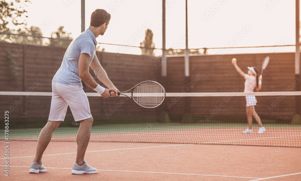 Couple playing tennis