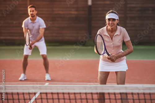 Couple playing tennis © georgerudy