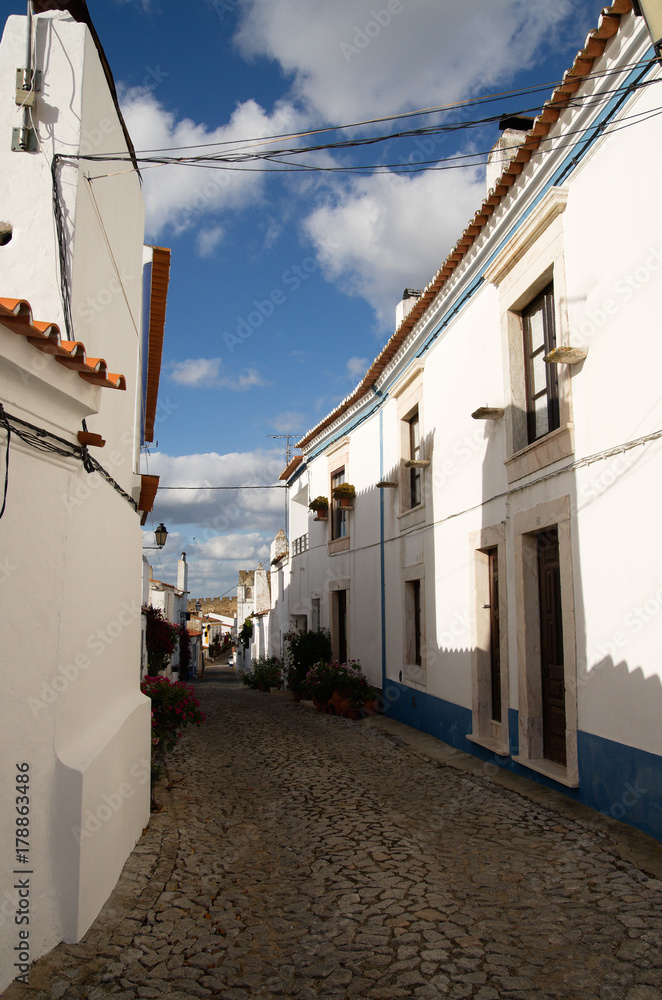 Typical narrow street of Terena village leading to castle