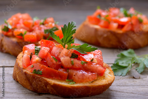 Tasty bruschetta with tomatoes and herbs