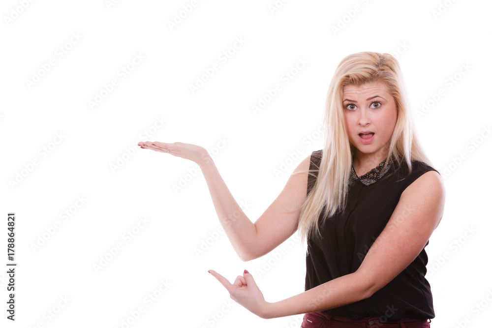 Blonde woman pointing with hands at copyspace Blonde woman pointing with hands at copyspace