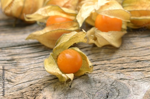 yellow organic physalis on a wooden board photo