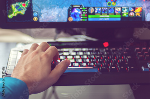 Man's hand plays PC game
