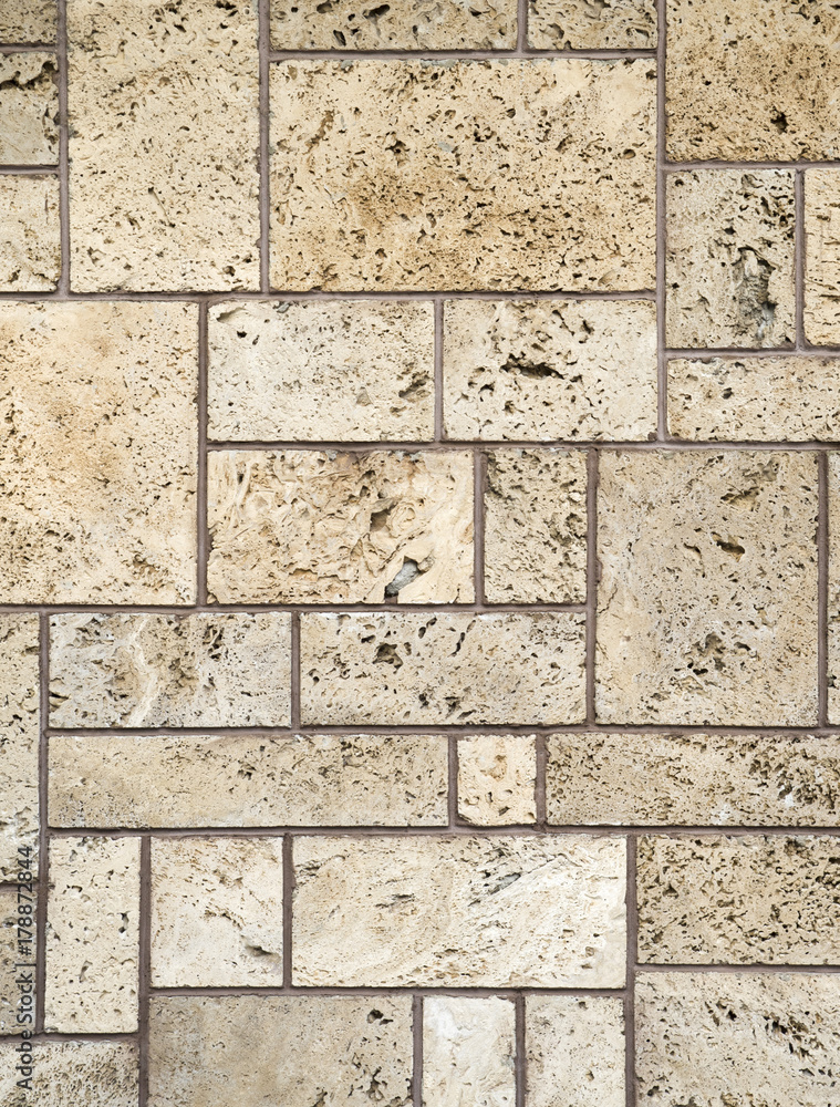 Fototapeta premium New ecru travertine wall closeup