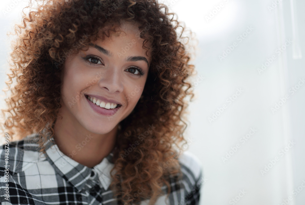 Portrait of a beautiful young woman with curly hair. Portrait of a beautiful young woman with curly hair.