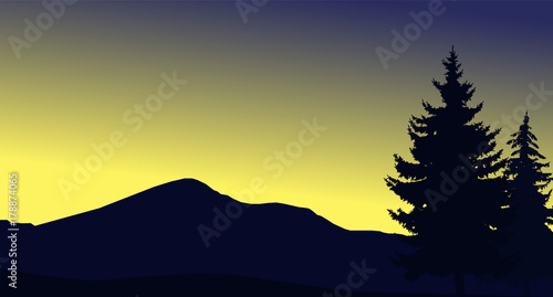 Image landscape of woodland and mountains. Yellow and blue sky.