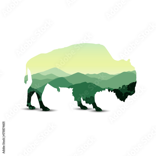 Silhouette of bison with mountain hills.