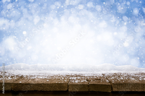 Desk of Wood and Snow - blue blurred background of winter and old shabby table