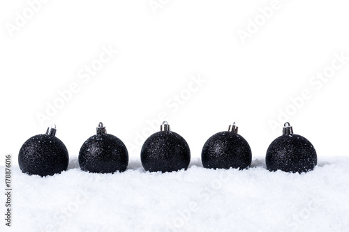 Five Black christmas balls with snow isolated on white background photo