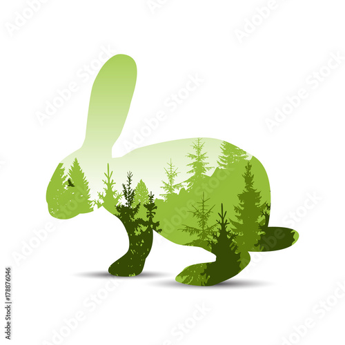  Silhouette of sitting rabbit with pine trees. Green tones. © yik2007