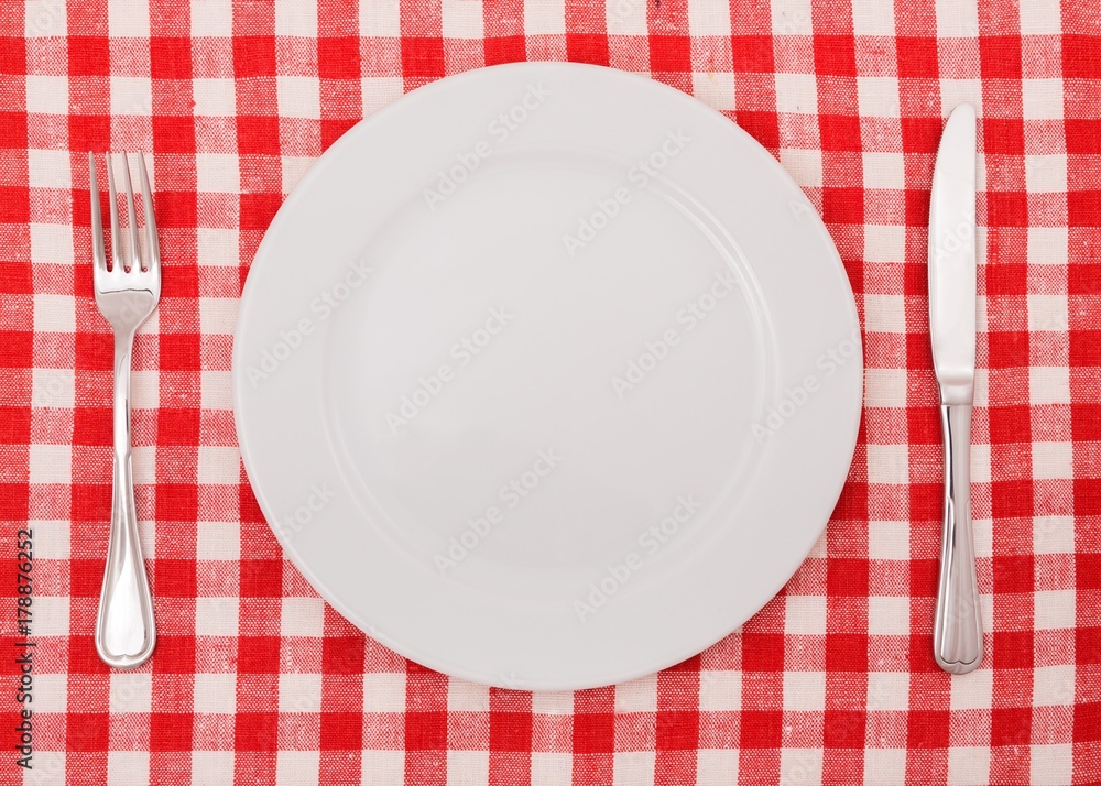 Table Setting with Plate, Fork and Knife on Checkered Table Table Setting with Plate, Fork and Knife on Checkered Table