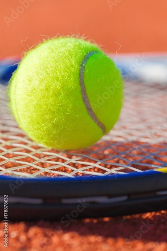 Tennis Racket and Ball on a Tennis Court © BillionPhotos.com