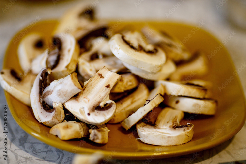sliced champignons on a yellow plate sliced champignons on a yellow plate