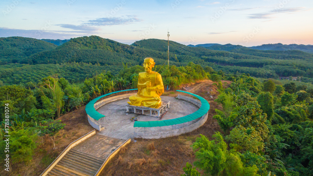 Golden big Buddha beside hight way