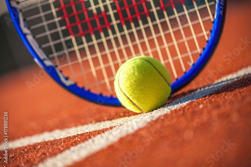 Tennis Racket and Ball on a Tennis Court © BillionPhotos.com