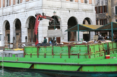 waste collection boat and an ancient palace in the background photo