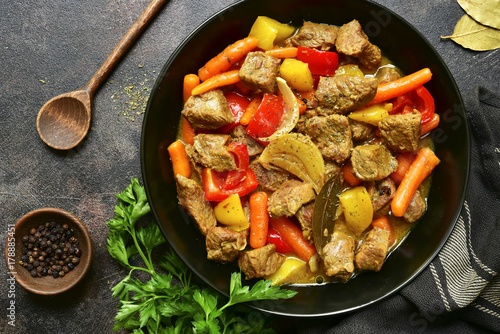 Fototapeta Meat stewed with vegetables.Top view with copy space.