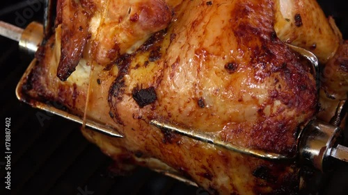 Fragrant chicken is roasted on skewers on the grill rotating