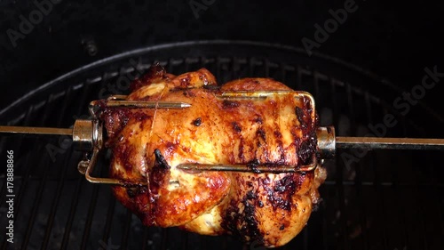Fragrant chicken is roasted on skewers on the grill rotating