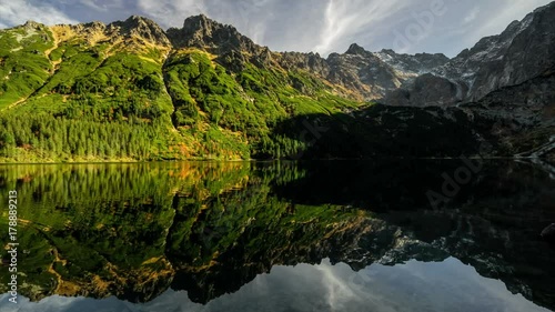 Time lapse reflection of clouds and shadow monsters in lake Morskie Oko, Tatras mountains, Poland landscape background
