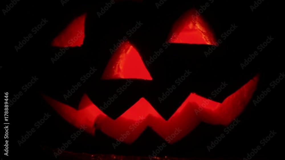 Halloween pumpkin glowing with a burning candle Halloween pumpkin glowing with a burning candle