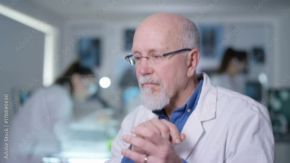 Scientist in white coat holding piece of clear material and using as interactive touch screen. Futuristic laboratory, science and research concept. Scientist in white coat holding piece of clear material and using as interactive touch screen. Futuristic laboratory, science and research concept.