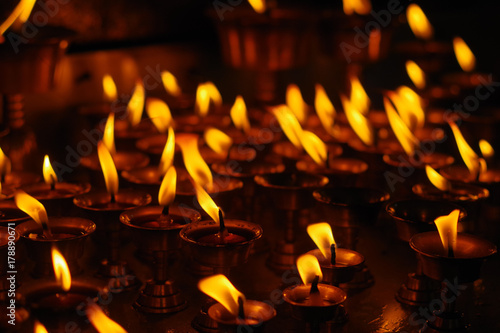 Burning candles in darkness inside temple. Kathmandu, Nepal, Asia