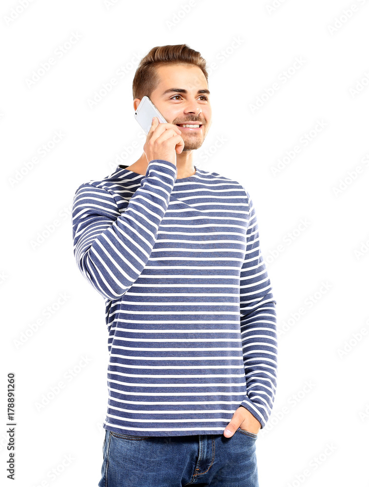 Young handsome man talking on his mobile phone against white background