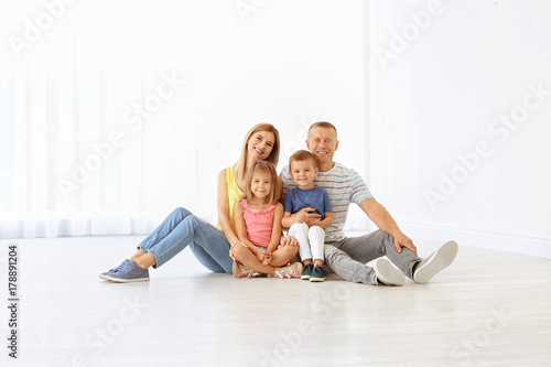 Happy family sitting on flo...