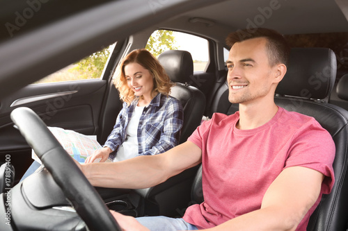 Beautiful young couple in car