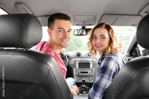 Beautiful young couple in car