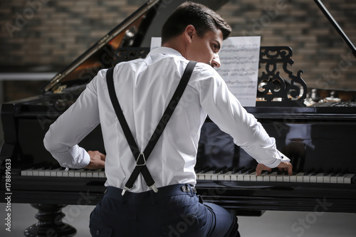 Young man playing piano ind...
