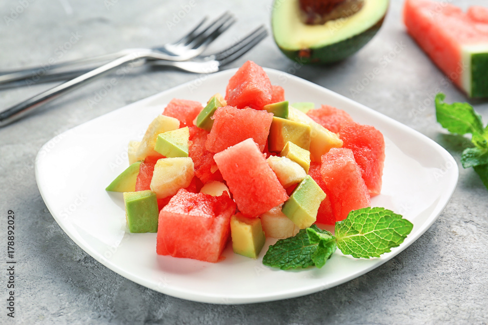 Plate of fresh salad with watermelon on table Plate of fresh salad with watermelon on table